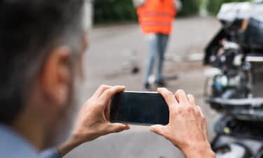 Man taking picture of car accident