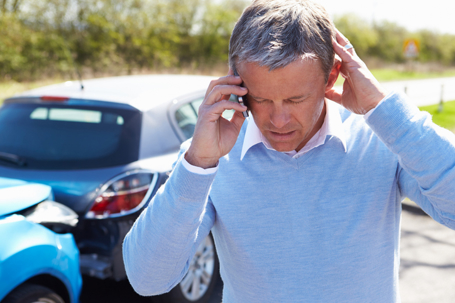 Man on phone after a car accident